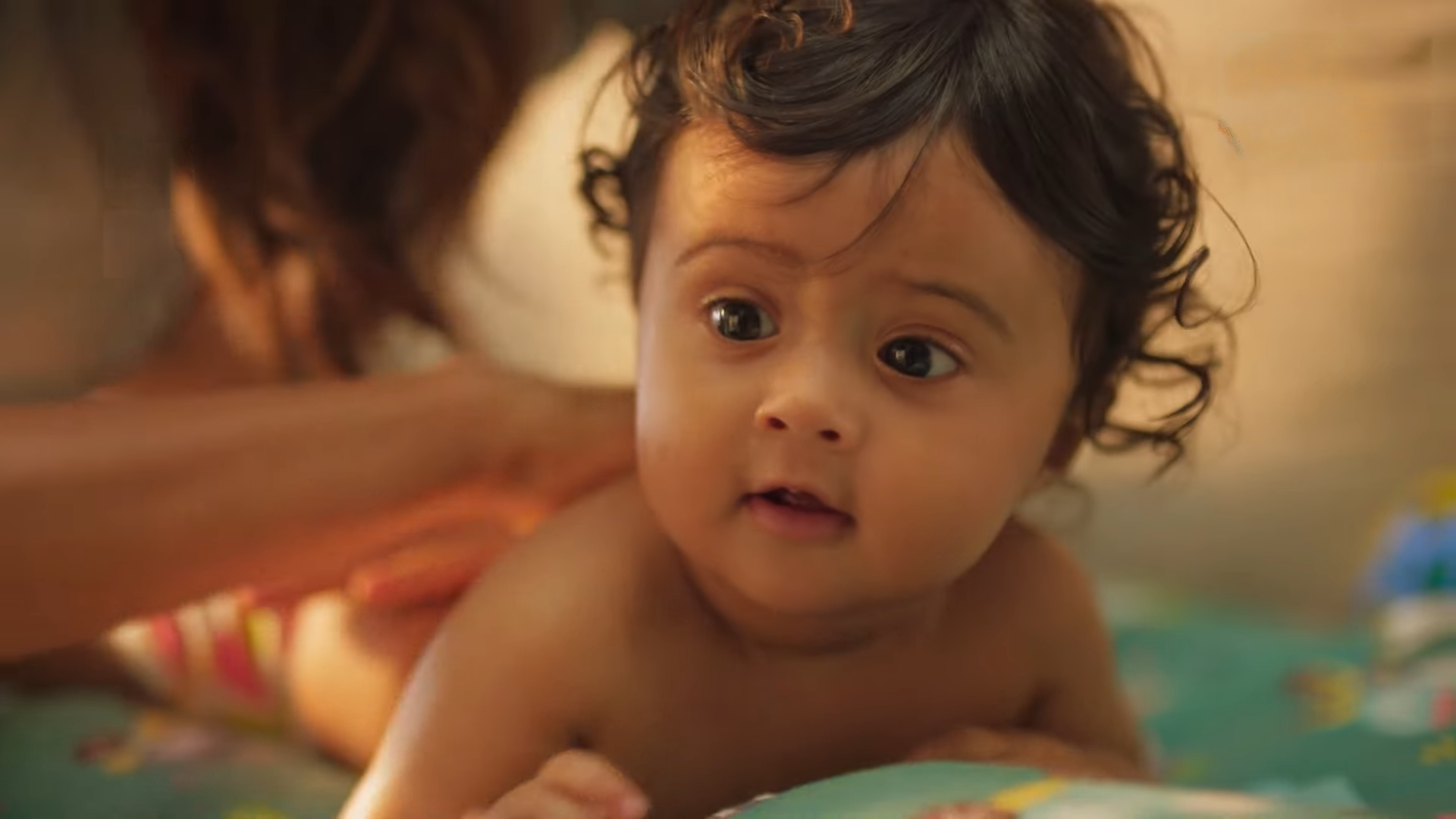 Image — Baby Massage Lifestyle · warm morning light, parent's hands